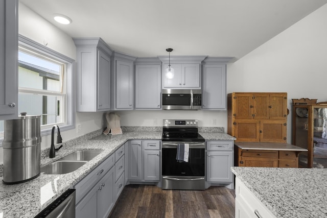 1072 Dugout Rd, Summertown, TN 38483 - kitchen with stainless steel appliances, gray cabinets, dark wood-style flooring, light stone countertops, and hanging light fixtures
