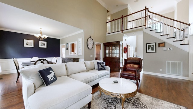 6300 Spera Pointe Xing, Hermitage, TN 37076 - living room featuring a chandelier, wood finished floors, ornamental molding, stairway, and a towering ceiling