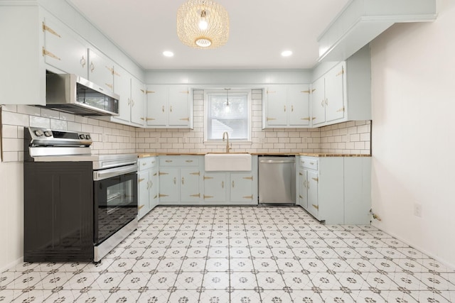 2108 Denham Ave, Columbia, TN 38401 - kitchen featuring stainless steel appliances, light floors, white cabinetry, and decorative backsplash