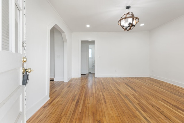 2108 Denham Ave, Columbia, TN 38401 - spare room with a chandelier, light wood-style floors, ornamental molding, and arched walkways