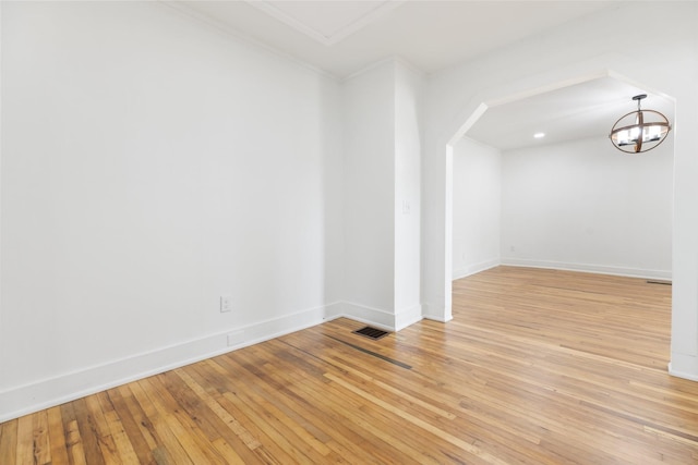 2108 Denham Ave, Columbia, TN 38401 - spare room with ornamental molding, light wood-type flooring, a chandelier, and arched walkways