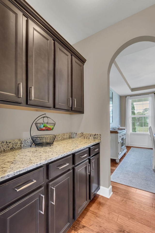 1060 Harvey Springs Dr, Spring Hill, TN 37174 - bar area featuring arched walkways and light wood-style floors