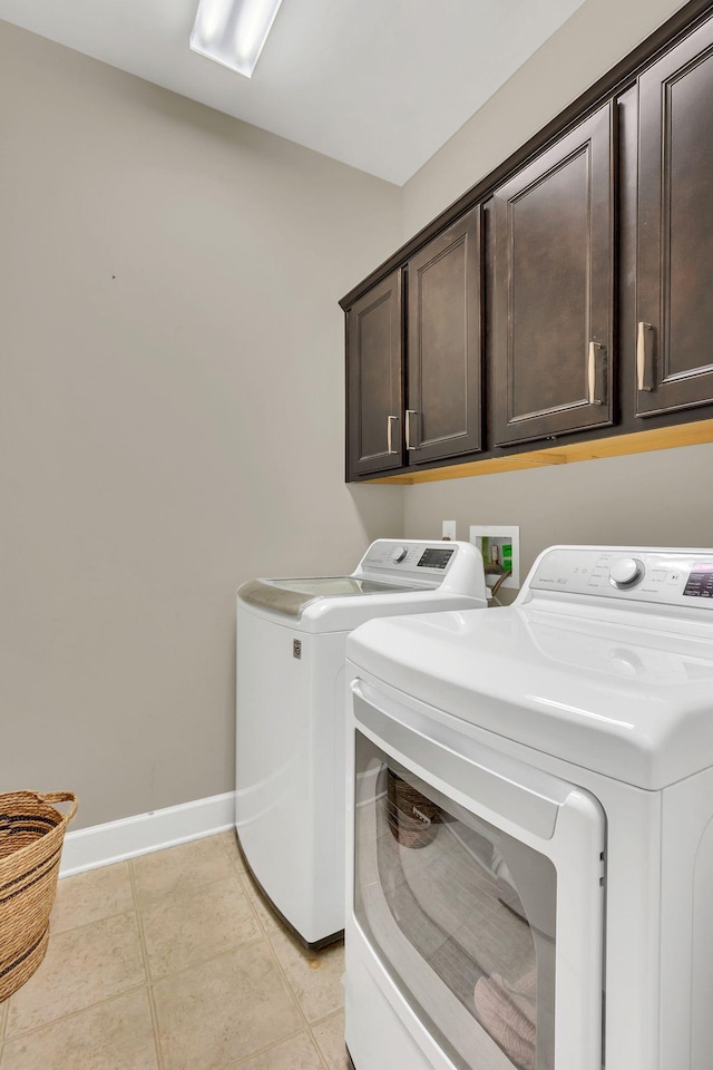 1060 Harvey Springs Dr, Spring Hill, TN 37174 - laundry room with cabinet space, washer and dryer, and light tile patterned floors