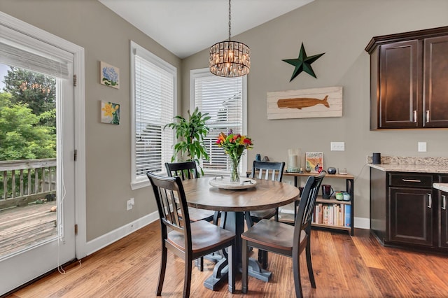 1060 Harvey Springs Dr, Spring Hill, TN 37174 - dining space with vaulted ceiling, light wood-type flooring, and a chandelier