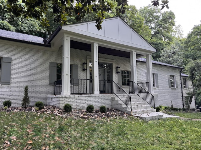 1125 Chickering Park Dr, Nashville, TN 37215 - view of front of house featuring brick siding, a front lawn, and covered porch
