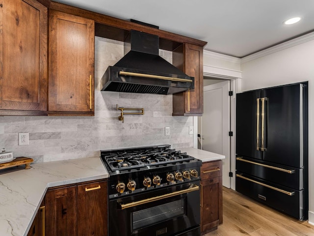 1015 Jump Off Rd, Bon Aqua, TN 37025 - kitchen featuring black appliances, wall chimney exhaust hood, ornamental molding, decorative backsplash, and light stone counters