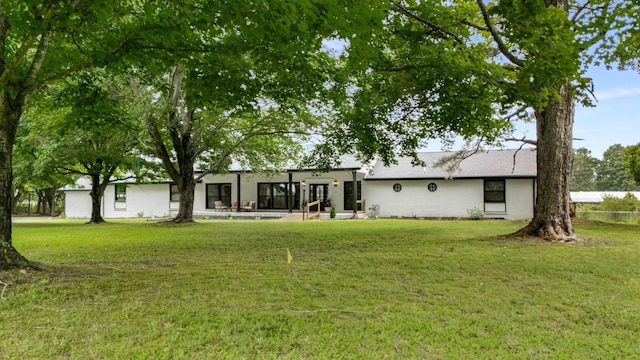 1015 Jump Off Rd, Bon Aqua, TN 37025 - back of house featuring a yard and stucco siding