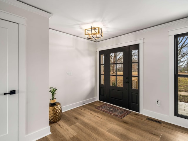 1015 Jump Off Rd, Bon Aqua, TN 37025 - entrance foyer featuring a chandelier, wood finished floors, and ornamental molding