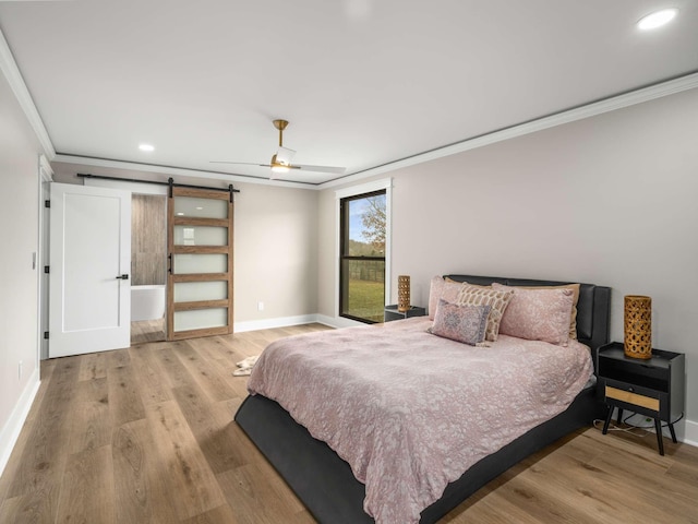 1015 Jump Off Rd, Bon Aqua, TN 37025 - bedroom with ornamental molding, a barn door, wood finished floors, recessed lighting, and ceiling fan