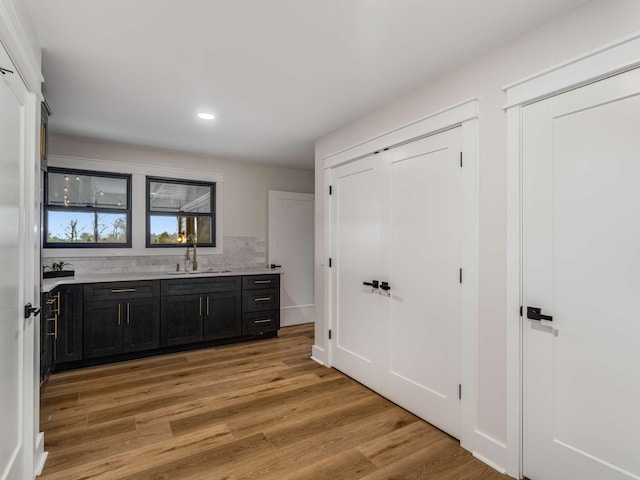 1015 Jump Off Rd, Bon Aqua, TN 37025 - kitchen featuring light countertops, light wood-style floors, recessed lighting, and dark cabinetry