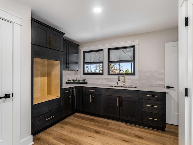 1015 Jump Off Rd, Bon Aqua, TN 37025 - kitchen featuring backsplash, light countertops, dark cabinetry, and recessed lighting