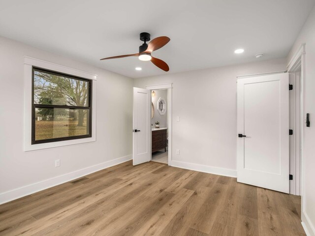 1015 Jump Off Rd, Bon Aqua, TN 37025 - unfurnished bedroom featuring wood finished floors, recessed lighting, ensuite bath, and ceiling fan