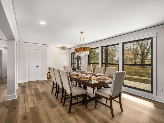1015 Jump Off Rd, Bon Aqua, TN 37025 - dining room with a chandelier, plenty of natural light, wood finished floors, recessed lighting, and ornamental molding