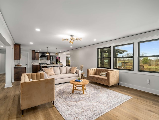 1015 Jump Off Rd, Bon Aqua, TN 37025 - living area featuring recessed lighting, plenty of natural light, wood finished floors, and a chandelier