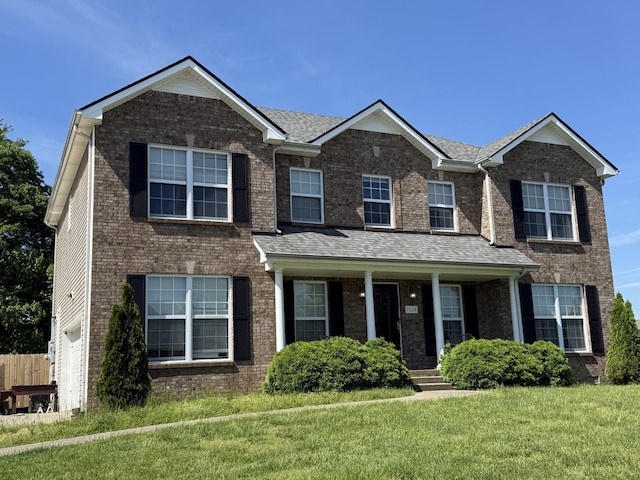 1024 Glenhurst Way, Clarksville, TN 37040 - view of front of house featuring a front yard, covered porch, brick siding, and roof with shingles