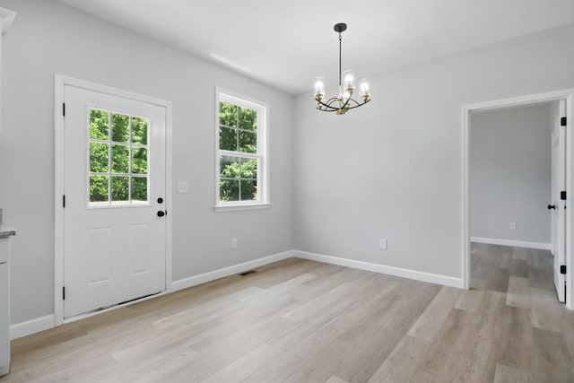 217 Dunnaway St, Shelbyville, TN 37160 - unfurnished dining area featuring a chandelier and light wood-type flooring