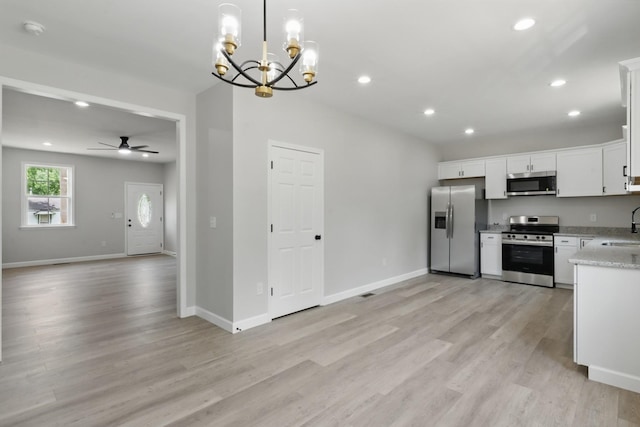 217 Dunnaway St, Shelbyville, TN 37160 - kitchen featuring stainless steel appliances, open floor plan, a chandelier, light wood-type flooring, and recessed lighting