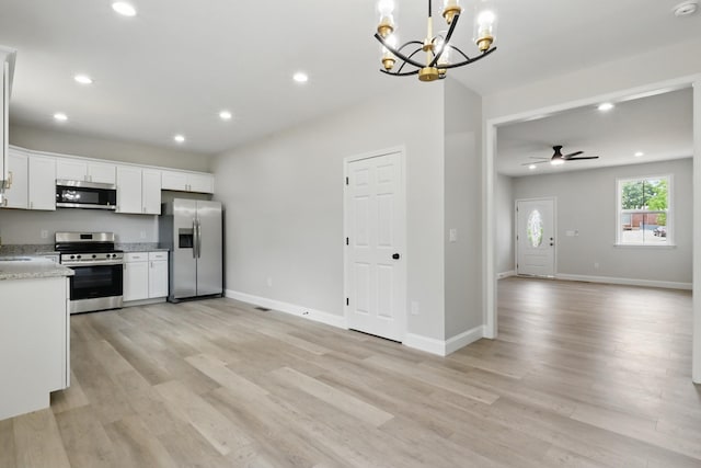 219 Dunnaway St, Shelbyville, TN 37160 - kitchen with stainless steel appliances, open floor plan, a chandelier, recessed lighting, and light wood-type flooring