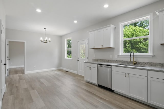 219 Dunnaway St, Shelbyville, TN 37160 - kitchen with stainless steel dishwasher, a chandelier, white cabinets, light wood-style floors, and light stone countertops