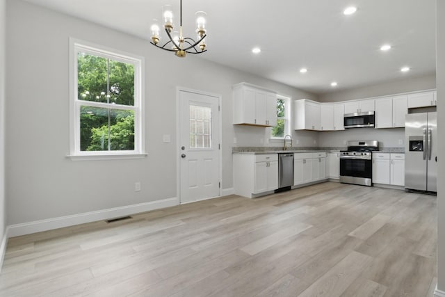 219 Dunnaway St, Shelbyville, TN 37160 - kitchen with stainless steel appliances, a chandelier, light wood-style floors, white cabinetry, and recessed lighting