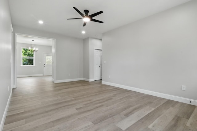 219 Dunnaway St, Shelbyville, TN 37160 - empty room featuring light wood-style flooring, a ceiling fan, recessed lighting, and a chandelier