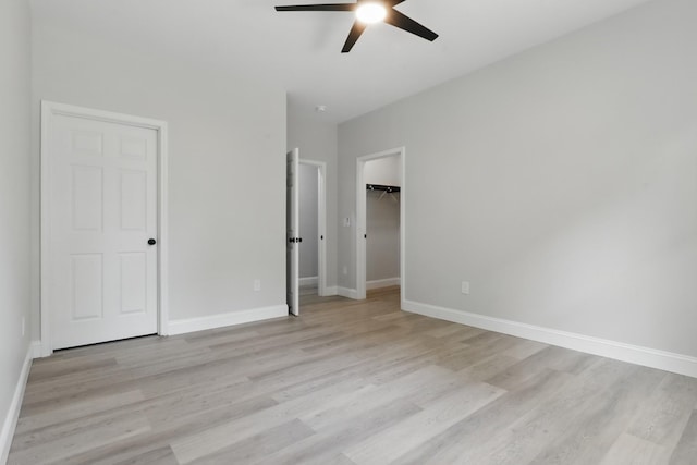 219 Dunnaway St, Shelbyville, TN 37160 - unfurnished bedroom with light wood-style floors, a ceiling fan, a spacious closet, and a closet