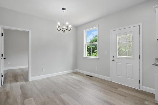 219 Dunnaway St, Shelbyville, TN 37160 - unfurnished dining area with light wood-style flooring and a chandelier