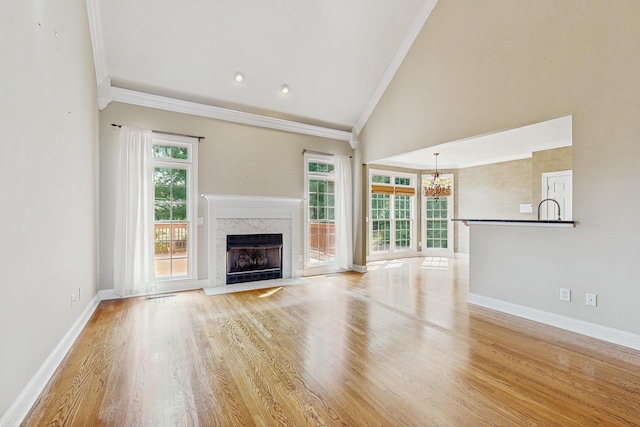 915 Joel Cheek Blvd, Franklin, TN 37064 - unfurnished living room featuring ornamental molding, a chandelier, a premium fireplace, light wood-type flooring, and high vaulted ceiling