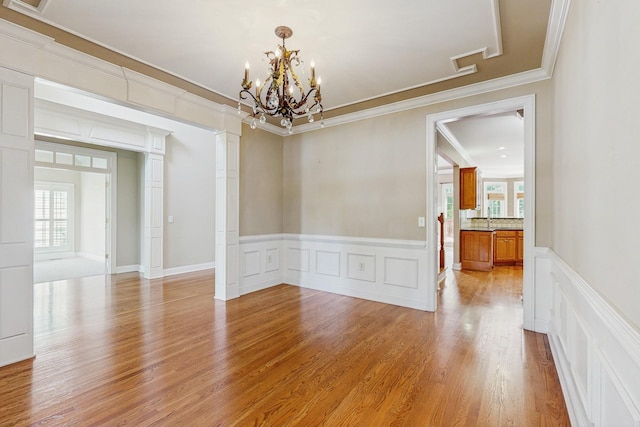 915 Joel Cheek Blvd, Franklin, TN 37064 - spare room featuring ornamental molding, a decorative wall, a chandelier, light wood-type flooring, and a wainscoted wall