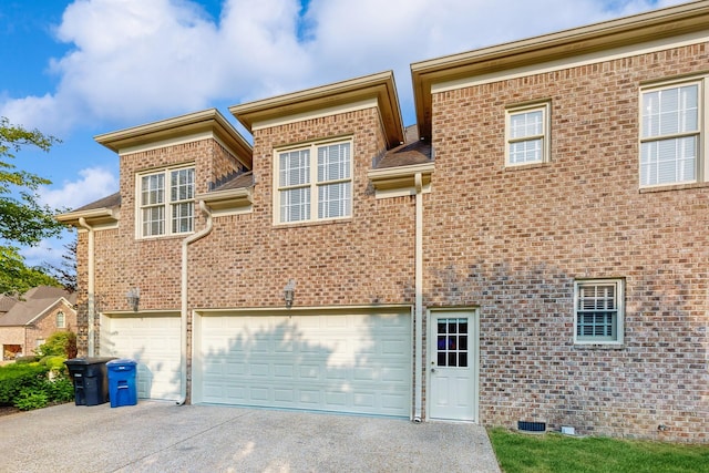 915 Joel Cheek Blvd, Franklin, TN 37064 - rear view of house with concrete driveway, a garage, and brick siding