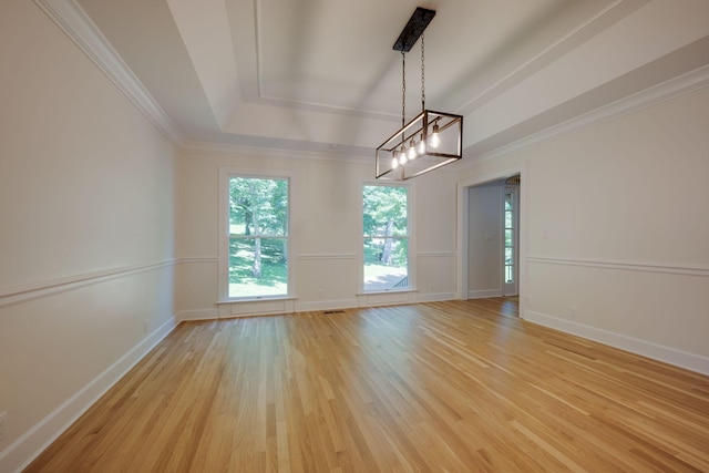 159 N Berwick Ln, Franklin, TN 37069 - empty room featuring a tray ceiling, light wood-style flooring, and crown molding