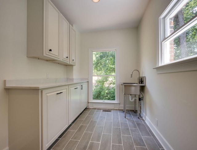 159 N Berwick Ln, Franklin, TN 37069 - laundry room featuring plenty of natural light and dark wood-style flooring