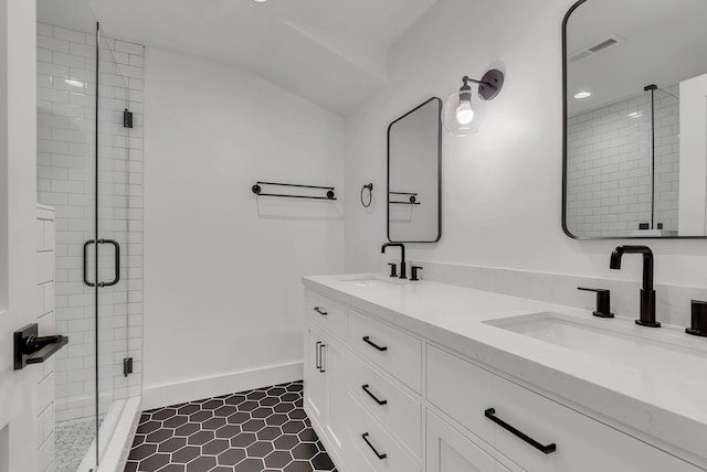 300 Natchez St, Franklin, TN 37064 - bathroom with double vanity, a shower stall, tile patterned flooring, recessed lighting, and vaulted ceiling