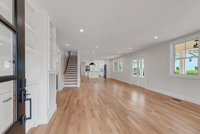 300 Natchez St, Franklin, TN 37064 - unfurnished living room with stairs, light wood-style floors, and recessed lighting