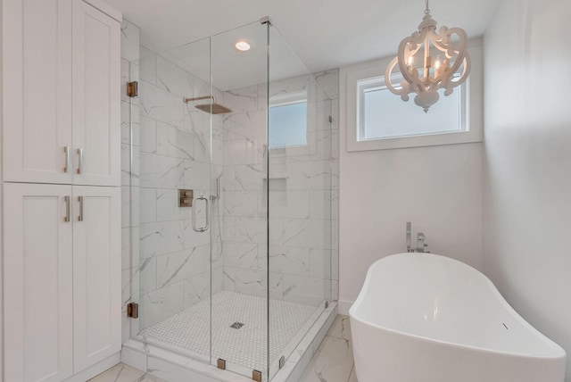 300 Natchez St, Franklin, TN 37064 - bathroom with a freestanding tub, marble look tiles, a chandelier, a marble finish shower, and recessed lighting