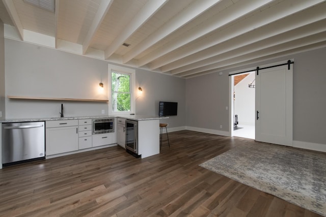 4150 Knipfer Rd, Joelton, TN 37080 - kitchen featuring appliances with stainless steel finishes, a barn door, a peninsula, white cabinets, and open floor plan