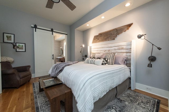 4150 Knipfer Rd, Joelton, TN 37080 - bedroom featuring a barn door, wood finished floors, recessed lighting, and a ceiling fan