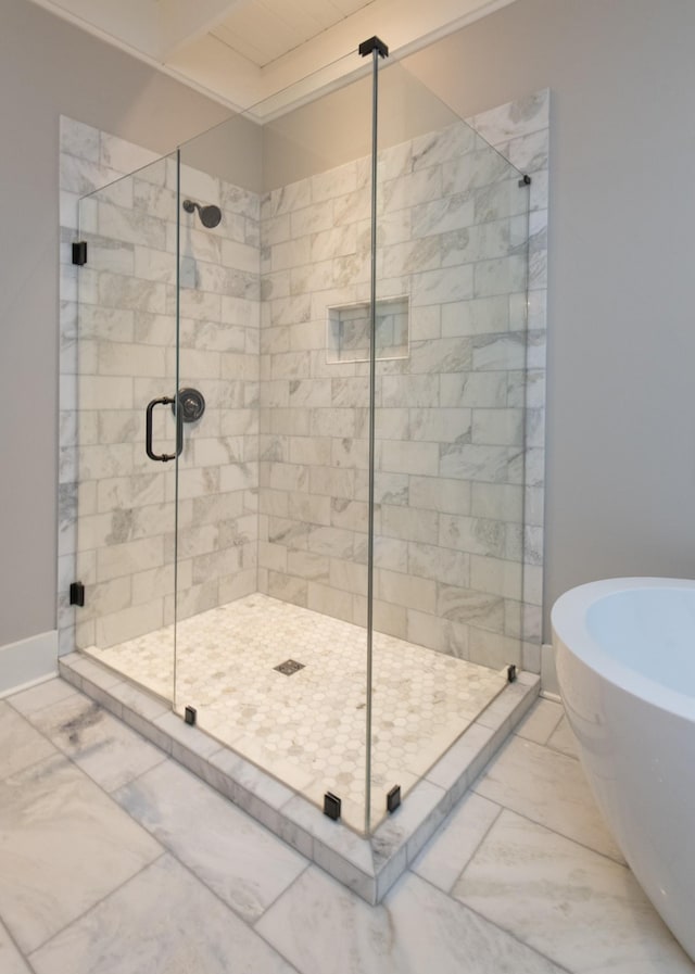 4150 Knipfer Rd, Joelton, TN 37080 - bathroom with marble look tiles, a freestanding tub, and a shower stall