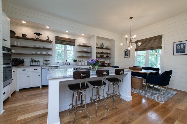 4150 Knipfer Rd, Joelton, TN 37080 - kitchen featuring open shelves, dishwashing machine, wooden walls, white cabinetry, and light stone countertops