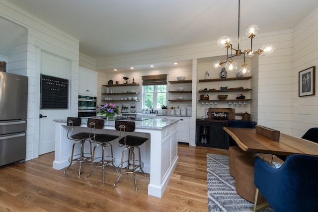 4150 Knipfer Rd, Joelton, TN 37080 - kitchen with open shelves, stainless steel appliances, white cabinetry, light wood-style flooring, and a breakfast bar area