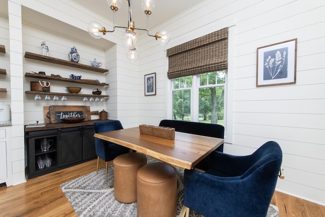 4150 Knipfer Rd, Joelton, TN 37080 - dining space with a chandelier, wooden walls, and light wood-style flooring