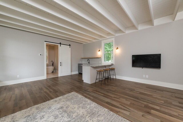 4150 Knipfer Rd, Joelton, TN 37080 - living room with a barn door, wood finished floors, and beam ceiling
