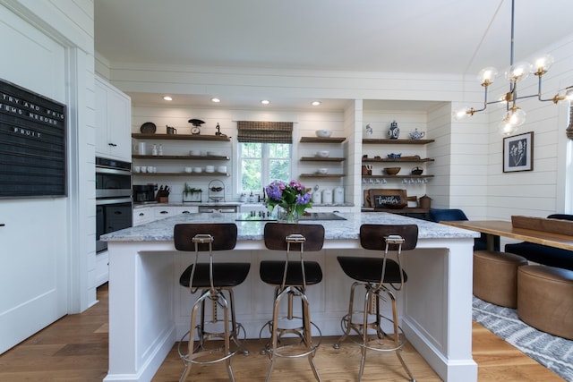 4150 Knipfer Rd, Joelton, TN 37080 - kitchen featuring open shelves, black electric cooktop, white cabinets, light wood-style floors, and light stone counters