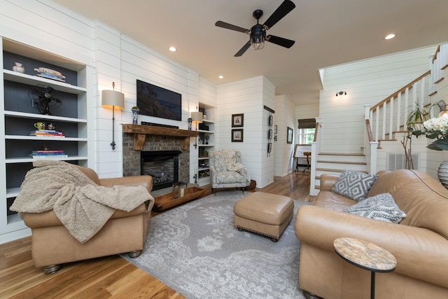 4150 Knipfer Rd, Joelton, TN 37080 - living area featuring wood finished floors, stairs, ceiling fan, a fireplace, and recessed lighting