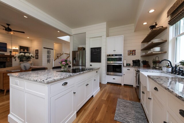 4150 Knipfer Rd, Joelton, TN 37080 - kitchen featuring stainless steel appliances, open shelves, wood finished floors, a ceiling fan, and a kitchen island