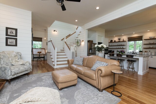 4150 Knipfer Rd, Joelton, TN 37080 - living room with stairs, wood finished floors, a ceiling fan, wood walls, and recessed lighting