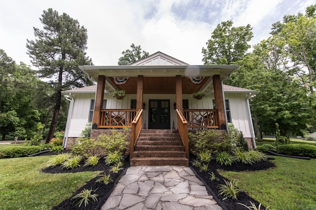 4150 Knipfer Rd, Joelton, TN 37080 - bungalow-style home with board and batten siding, covered porch, french doors, and a front yard