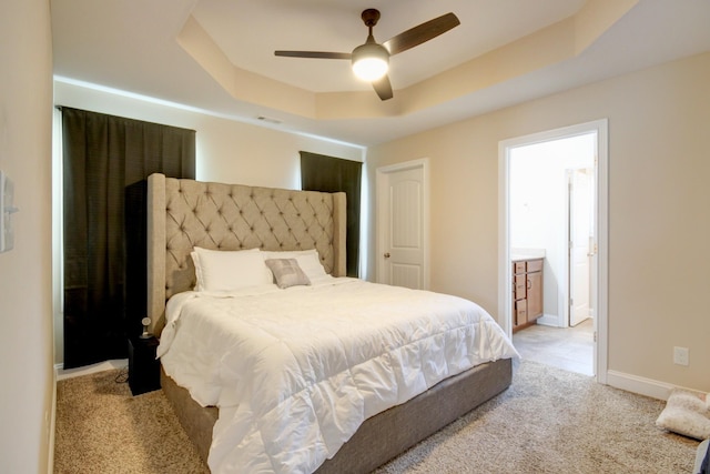 1029 Charles Thomas Dr, Clarksville, TN 37042 - bedroom with a raised ceiling, light colored carpet, a ceiling fan, and ensuite bath