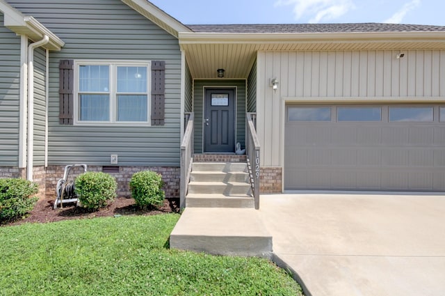 1029 Charles Thomas Dr, Clarksville, TN 37042 - view of exterior entry with an attached garage, driveway, and roof with shingles