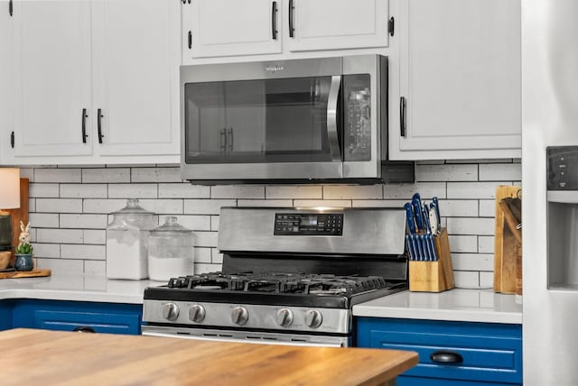 1805 Needmore Rd, Clarksville, TN 37042 - kitchen featuring stainless steel appliances, tasteful backsplash, blue cabinets, and white cabinets